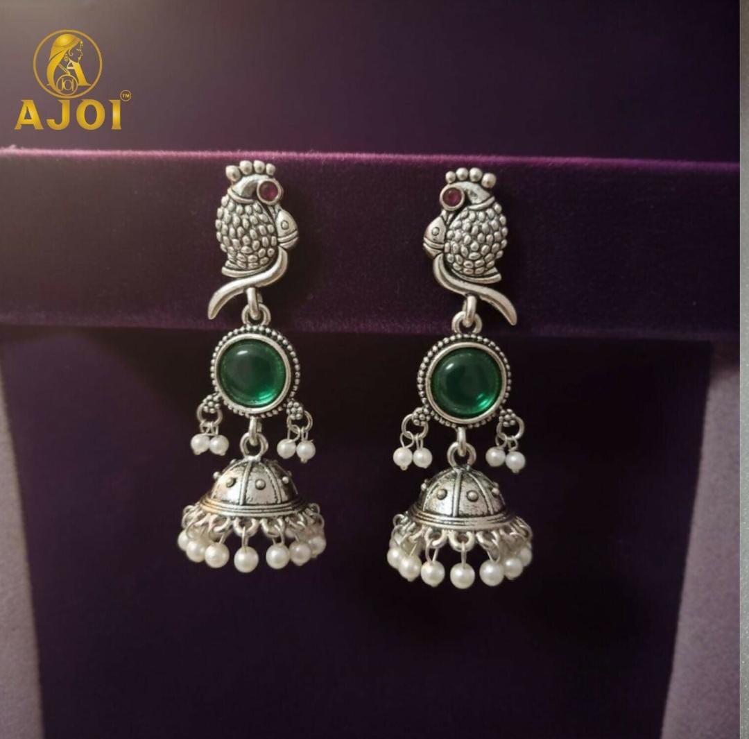 Handicrafted antique silver peacock Jhumka earrings with Emarald green stone and pearl drop detailing
