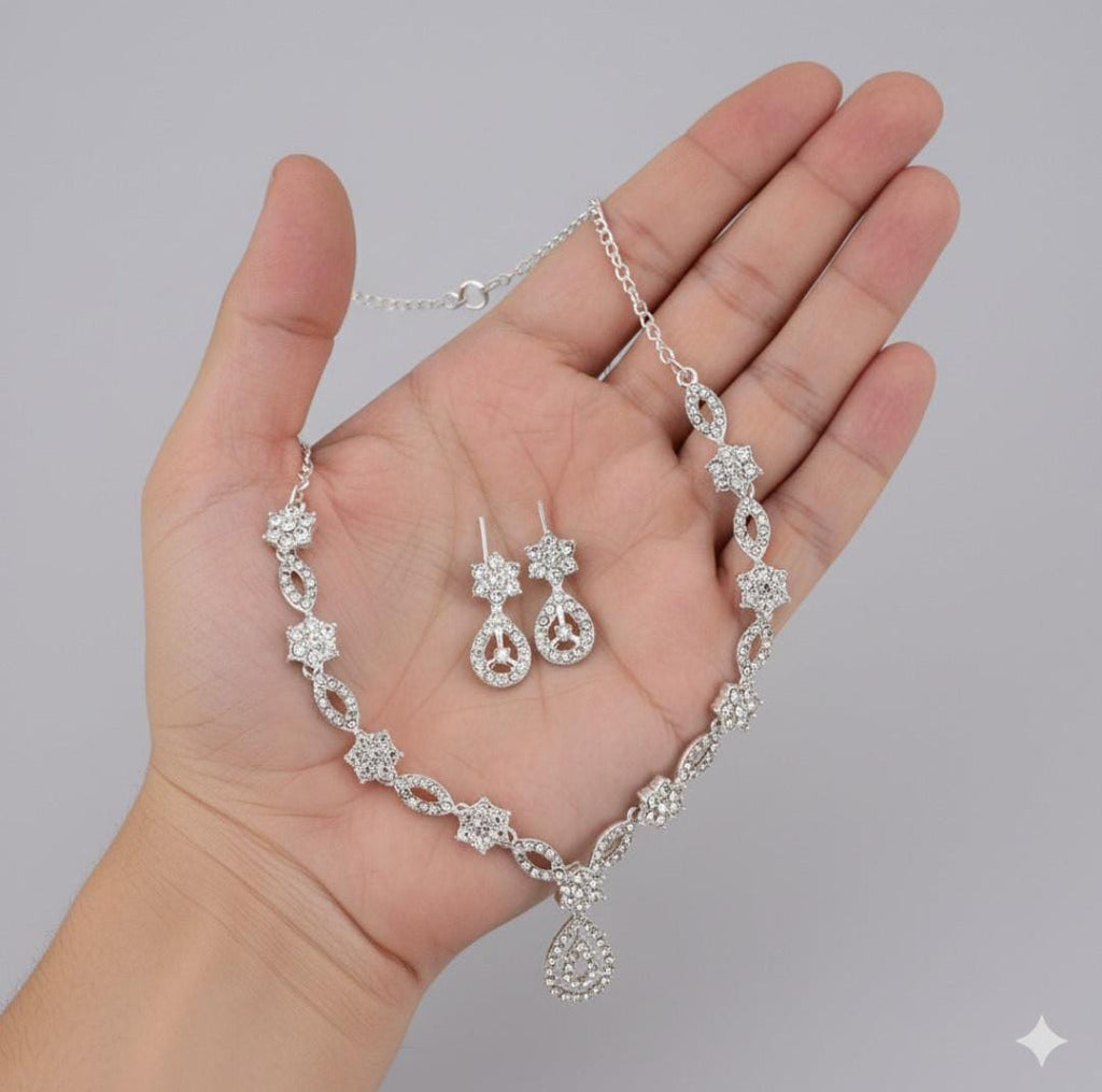 Elegant crystal and enamel leaf link necklace set with pearl drop.