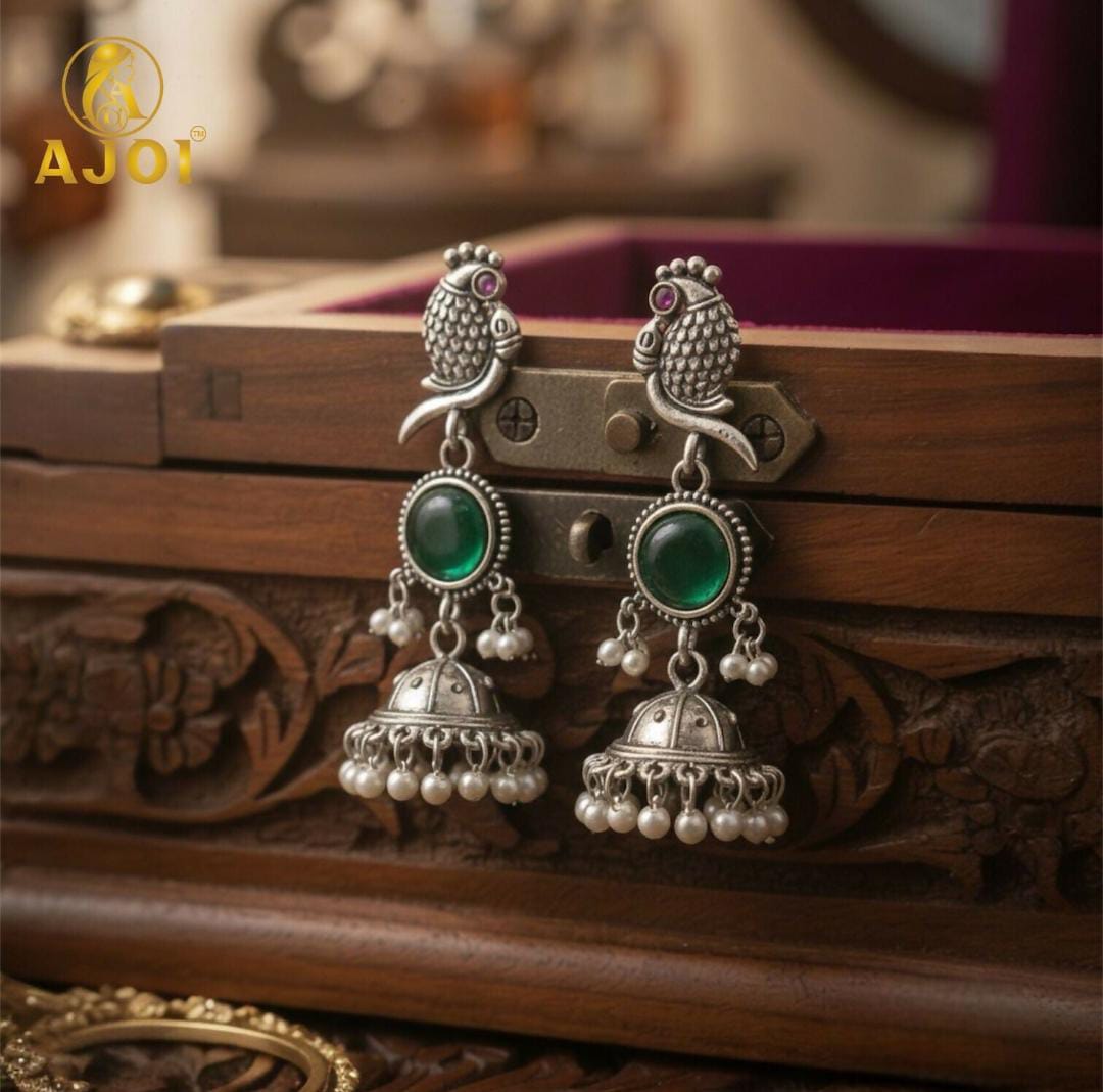 Handicrafted antique silver peacock Jhumka earrings with Emarald green stone and pearl drop detailing