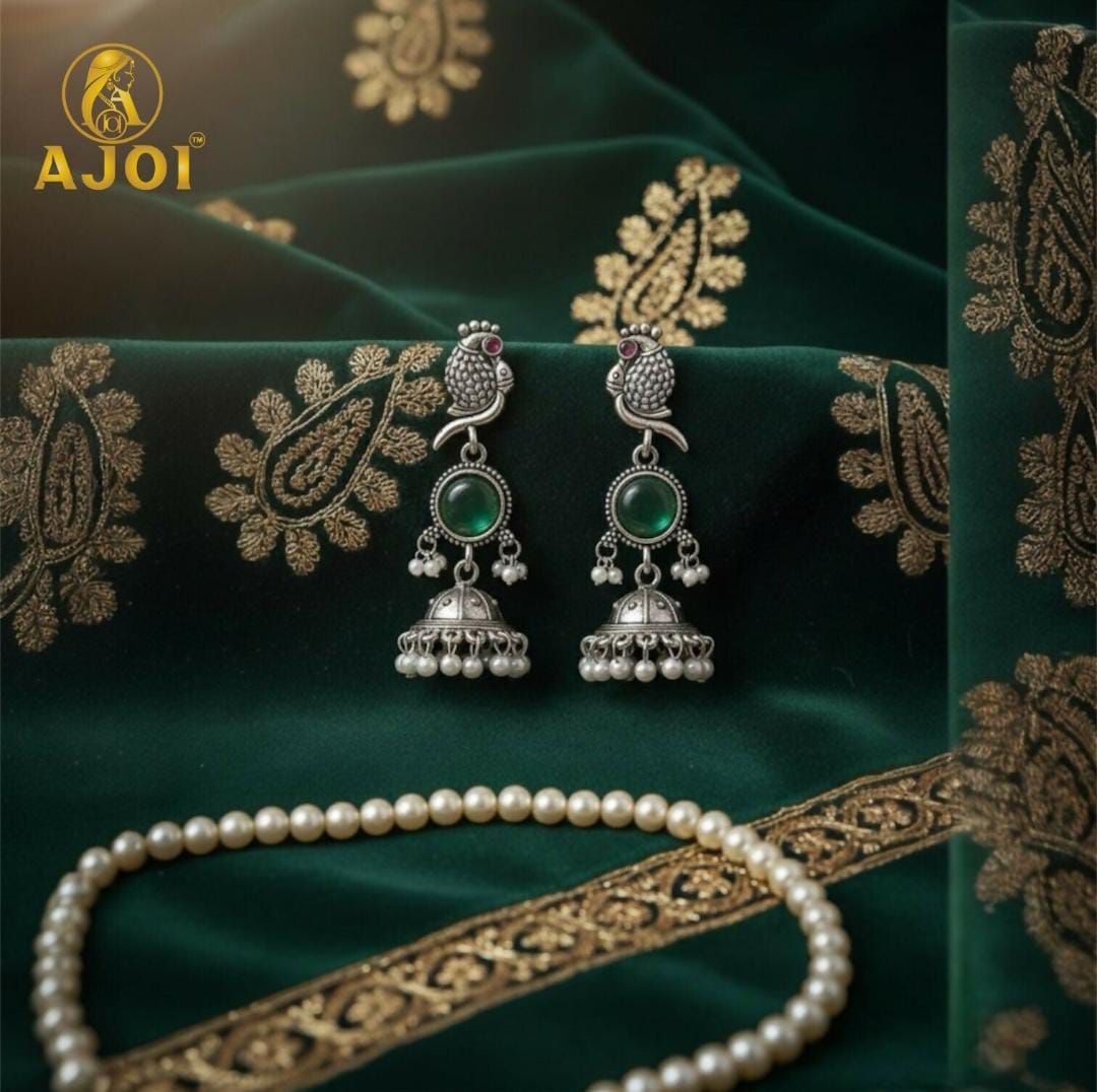 Handicrafted antique silver peacock Jhumka earrings with Emarald green stone and pearl drop detailing