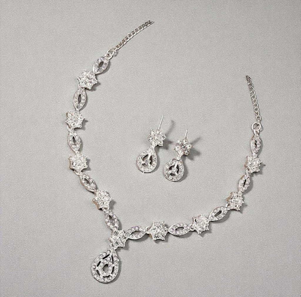 Elegant crystal and enamel leaf link necklace set with pearl drop.