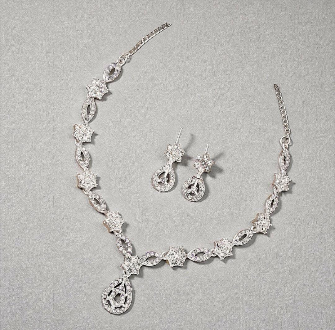 Elegant crystal and enamel leaf link necklace set with pearl drop.